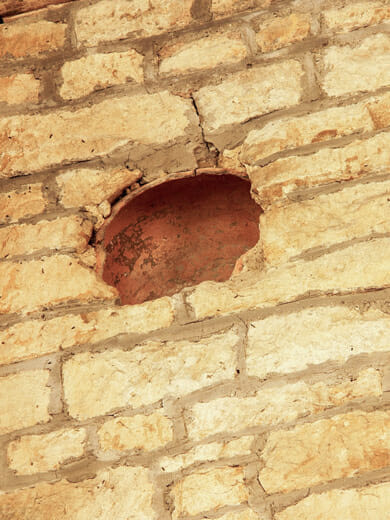 Jar built into a wall for acoustic absorption.